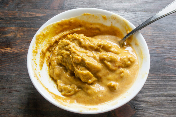 Mixing the Mustard to a Smooth Consistency Whisking the mustard in a bowl until it is smooth and creamy.