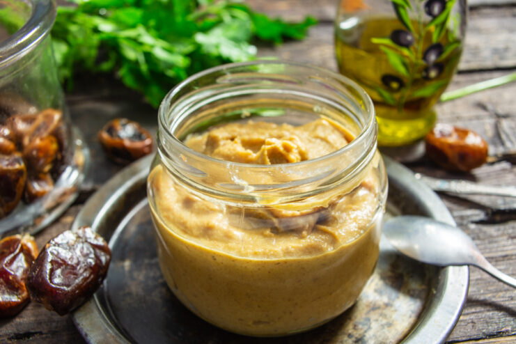 A jar of homemade mustard with dates, ready to be served.