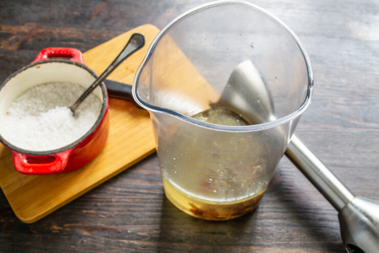 Preparing the Liquid Base in a Blender Cup Pouring boiling water into a tall cup for an immersion blender.