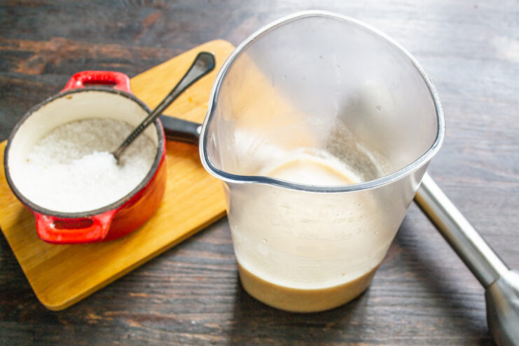 Preparing the Liquid Base in a Blender Cup Pouring boiling water into a tall cup for an immersion blender.