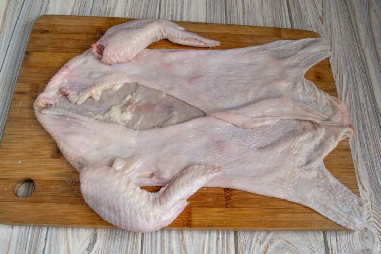 Preparing the chicken skin 'suit' for stuffing The whole chicken skin with wings attached, rinsed and ready for stuffing.
