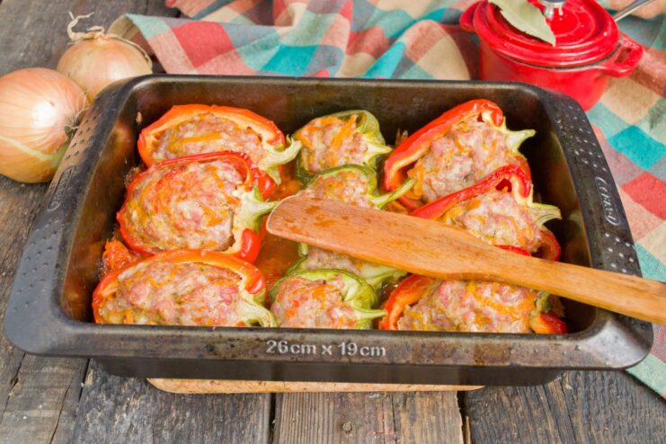 Baking the Stuffed Peppers in the Oven The baking dish with stuffed peppers inside the oven, baking until tender and cooked through.
