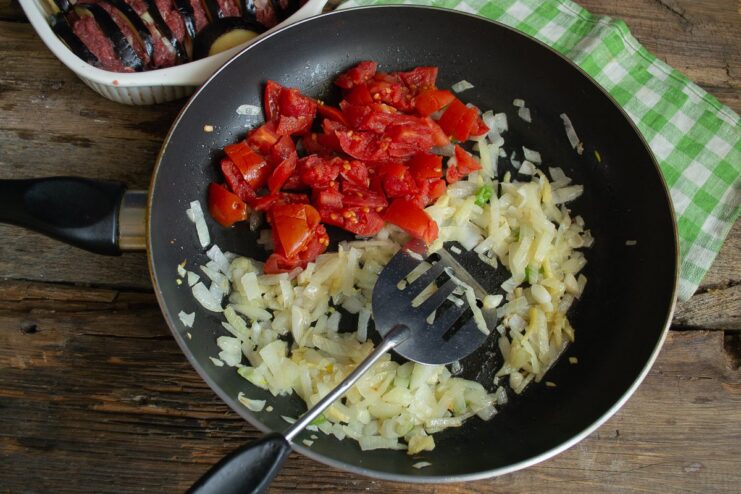 Making the Vegetable Sauce and Blending until Smooth An immersion blender pureeing cooked tomatoes and onions in a pan to make a smooth sauce.