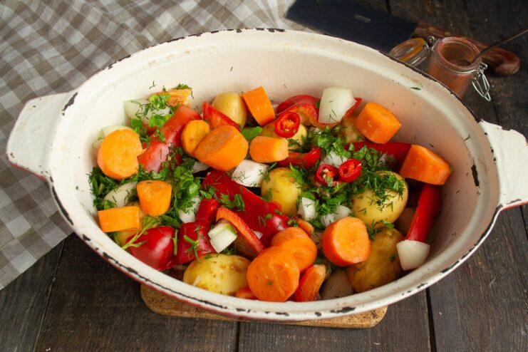 Adding Carrots for Sweetness and Texture Large chunks of carrots being added to the stew pot.