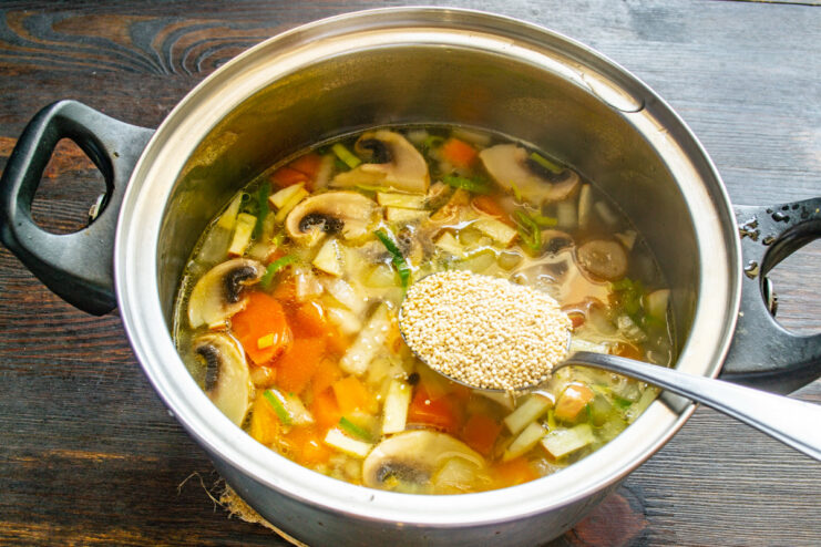 Adding Nutritious Quinoa Quinoa being added to the pot of soup.