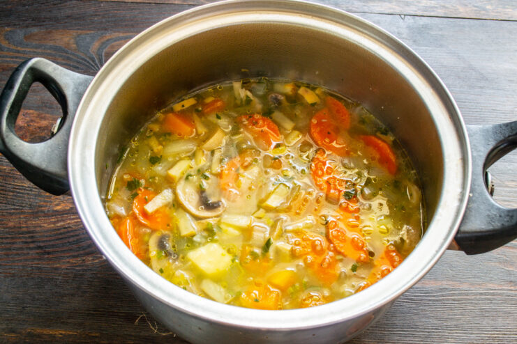 Simmering the Soup to Perfection The soup simmering gently in a pot on the stove.