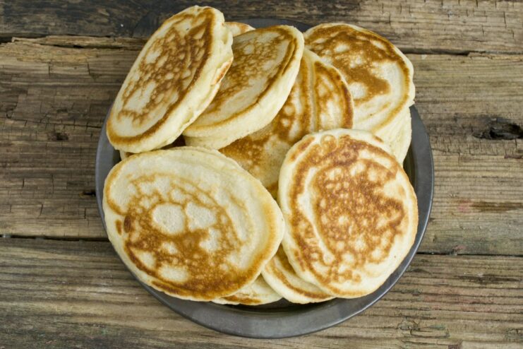 Frying Kefir Pancakes to Golden Perfection Golden-brown kefir pancakes being fried in a non-stick skillet.