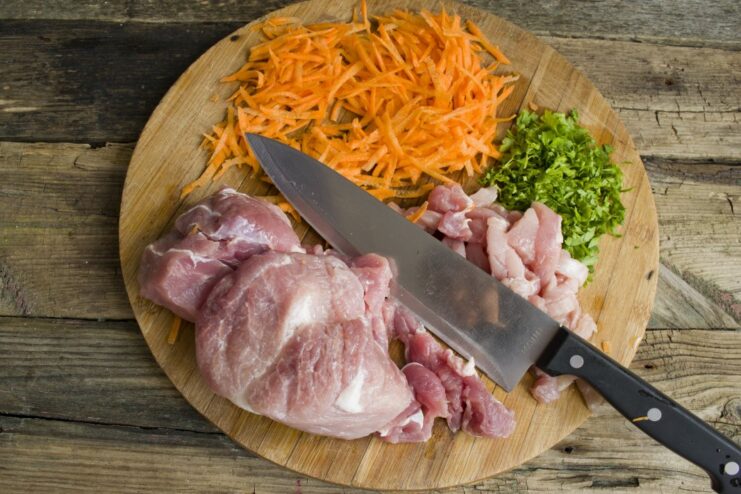 Prepping Ingredients for the Pork Goulash Sliced lean pork, chopped onions, and grated carrots ready for making the goulash.