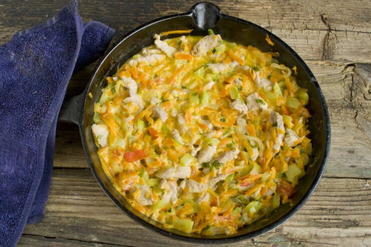 Simmering the Pork Goulash in Creamy Smetana Sauce Pork goulash with vegetables simmering in a creamy smetana sauce in a deep skillet.