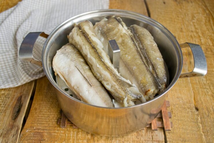 Steaming Hake to Perfection Hake fillets cooking in a steamer basket over a pot.