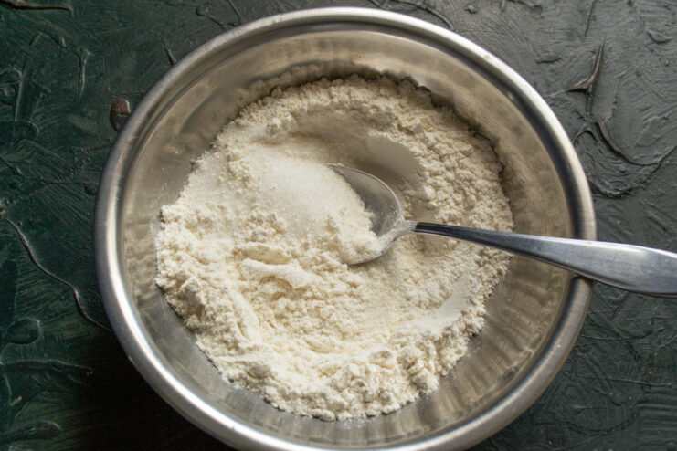 Measuring all-purpose flour for the cookie dough A bowl of all-purpose flour being measured for the Nascondini cookie recipe.