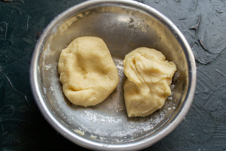 Quickly kneading the shortbread dough Hands quickly kneading the cookie dough into a ball.