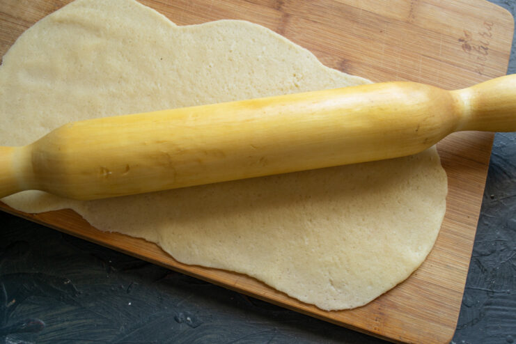 Rolling out the plain dough for Nascondini cookies The plain shortbread dough rolled out into a thin rectangle on a floured surface.