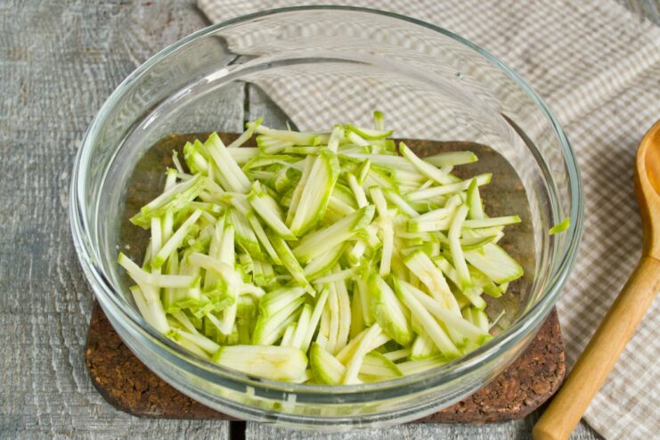 Preparing the Zucchini Base for Fritters: Grate Finely A bowl of finely grated zucchini, ready for making fritters.