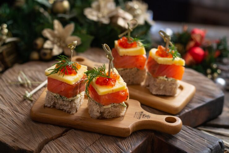 A platter of salmon canapés with red caviar, ready for a festive buffet table.