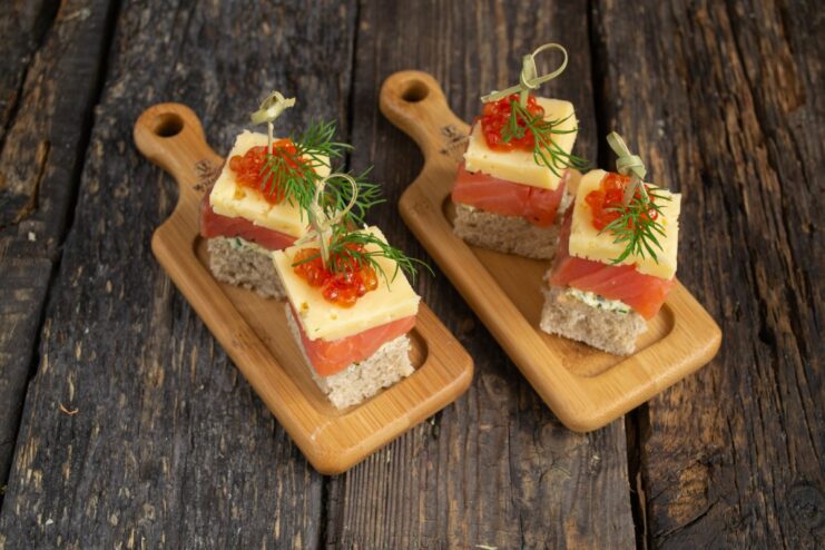 Serving salmon canapés on a buffet table A platter of elegant salmon canapés arranged on a buffet table for a party.