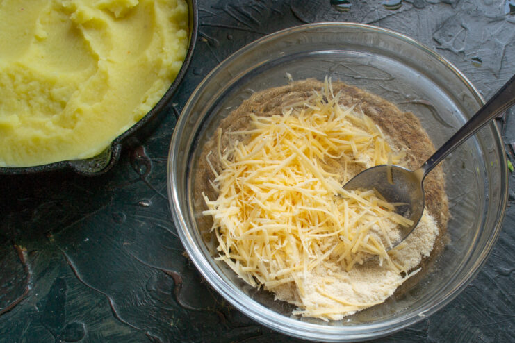 Preparing the crispy topping with cheese and breadcrumbs A bowl containing a mixture of grated cheese and ground breadcrumbs for the casserole topping.