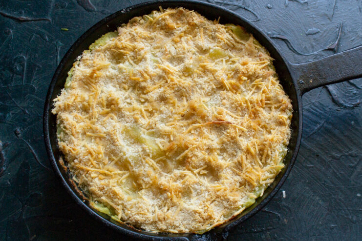 Baking the casserole in a preheated oven The assembled potato and fish casserole in a skillet, ready to be baked in the oven.