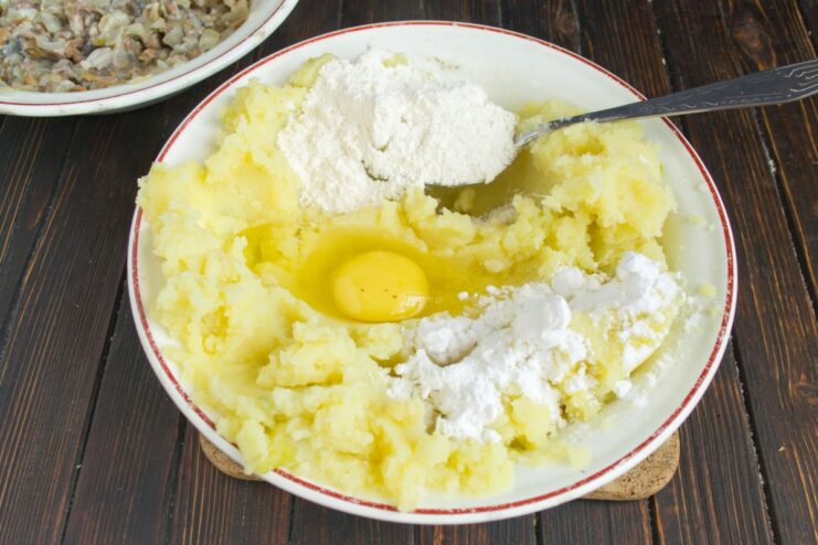Preparing the Potato Dough for the Cutlets Mixing mashed potatoes with flour and egg to form a dough.