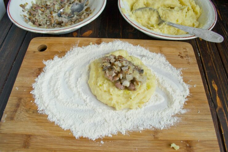 How to Shape the Mushroom-Stuffed Potato Cutlets A hand shaping a potato patty, placing the mushroom filling in the center.