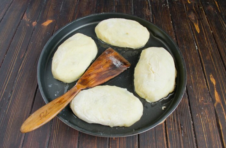 Frying the Potato Cutlets to Perfection Potato cutlets frying in a pan, turning a beautiful golden-brown color.