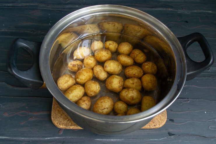 Parboiling New Potatoes for the Salad Small new potatoes in a pot of boiling water, the first step in making the salad.