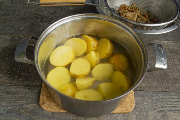 Step 1: Boiling new potatoes until tender. A pot of new potatoes boiling in water.
