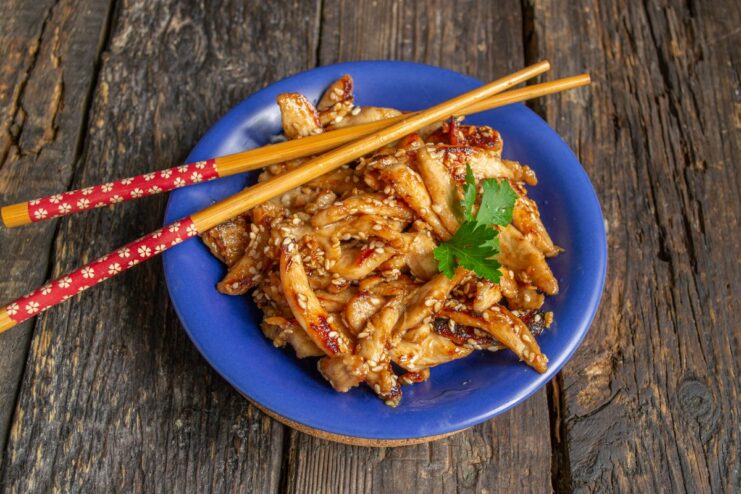 The finished sweet and sour teriyaki chicken served on a plate, ready to eat.