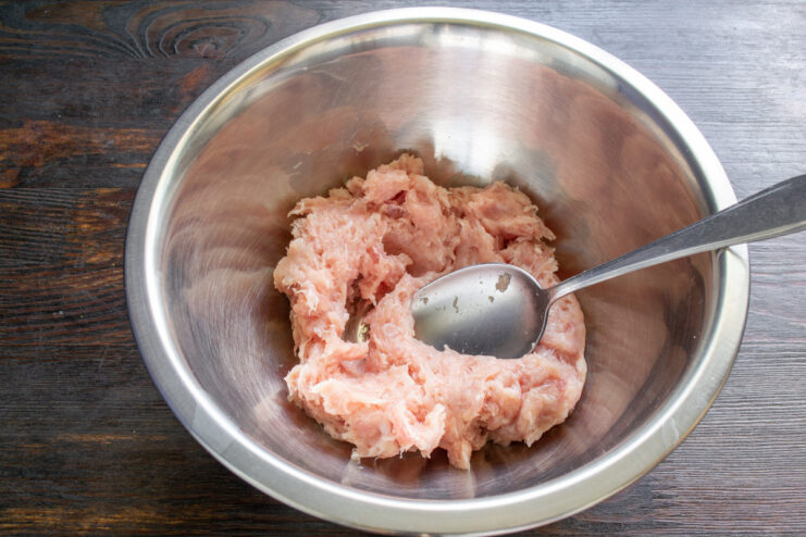 Preparing the Meat Base for Sausages A deep bowl containing a mixture of ground pork and chicken for making sausages.