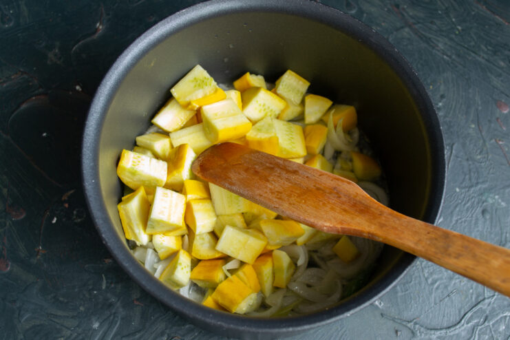Preparing the zucchini: uniform cubes ensure even cooking A pile of freshly diced zucchini cubes on a cutting board.