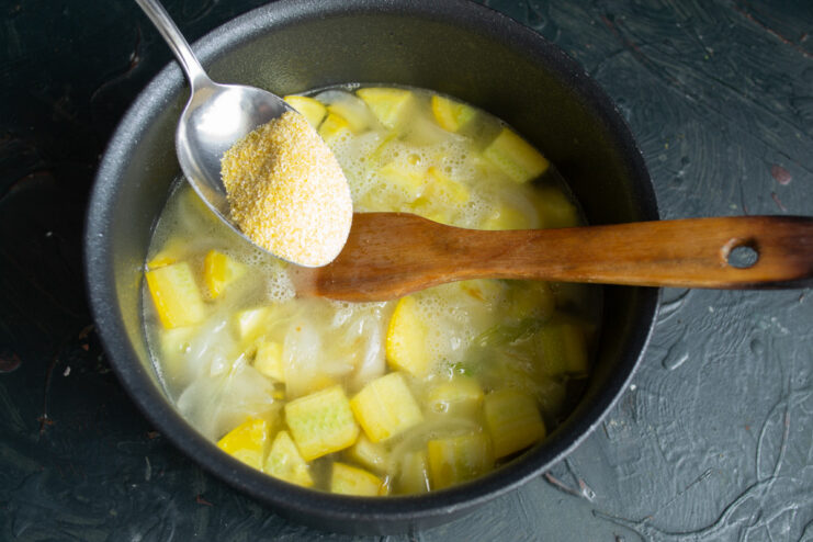 Tip for smooth soup: add polenta gradually while stirring to prevent lumps Polenta being poured in a thin stream into the simmering soup pot.