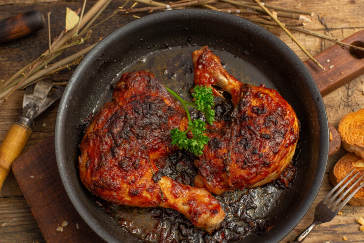 A plate of oven-baked BBQ chicken, glazed and ready to serve.