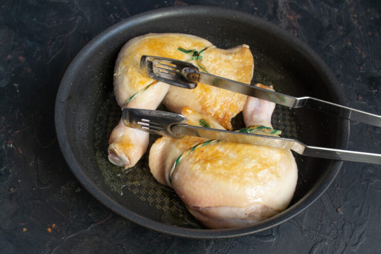 Searing Chicken on High Heat to Lock in Juices Chicken leg quarters searing in a skillet, developing a golden-brown crust.