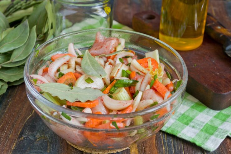 Tossing Everything Together to Combine Flavors A bowl of chicken, vegetables, and spices being mixed thoroughly.
