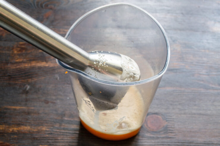 Blending Ginger, Garlic, and Chili for the Sauce Base A blender jar containing ginger, garlic, chili, and water, ready to be blended into a smooth sauce.