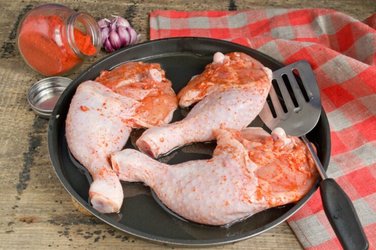 Step 7: Searing the chicken until golden-brown on each side Chicken legs sizzling in a hot pan, getting a crispy, golden-brown skin.