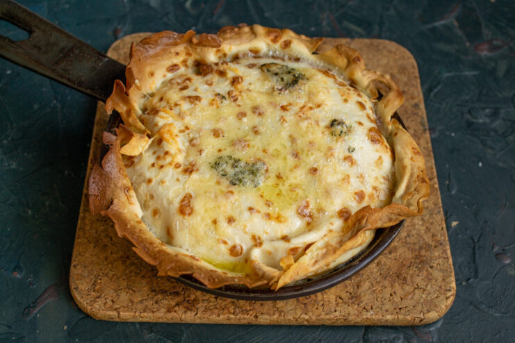 The finished golden-brown Lazy Kulebyaka pie in its baking dish, ready to be served.