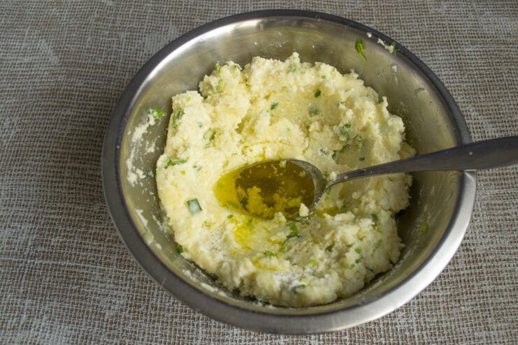 Mixing salt, olive oil, and other ingredients for the lazy varenyky dough in a bowl.