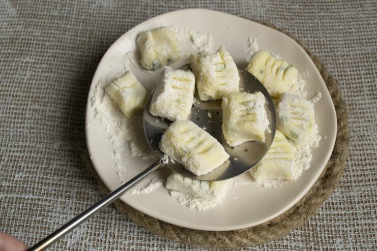 Lazy varenyky dumplings cooking in a pot of boiling water.
