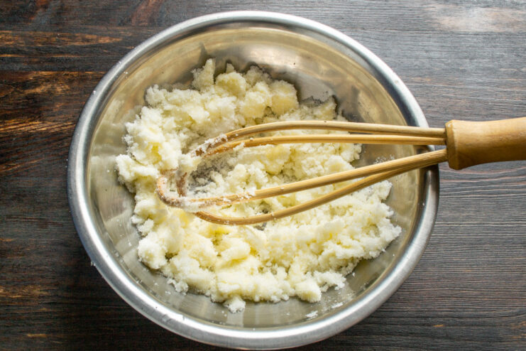 Step 1: Creaming butter and sugar for the muffin batter A bowl with softened butter and sugar being mixed together with a spatula.