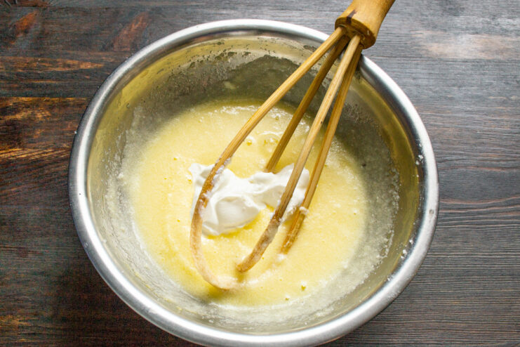 Step 3: Whisking the wet ingredients until smooth A smooth, pale yellow batter of butter, sugar, and egg in a mixing bowl.