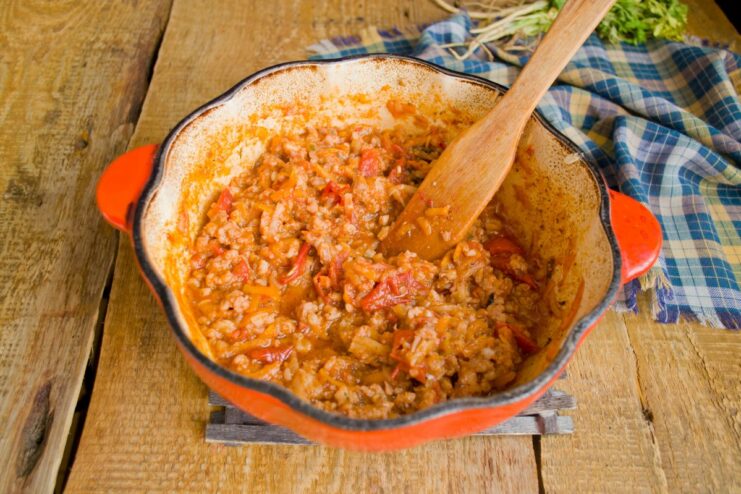 Letting the sauce simmer allows all the flavors to meld together perfectly. The rich, red meat sauce simmering gently in a covered pot.