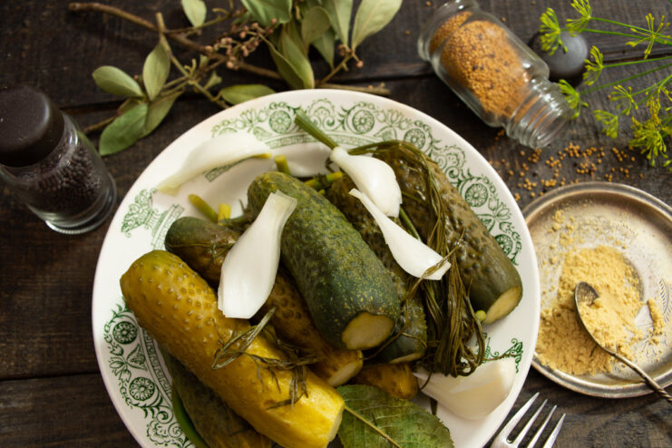 A jar of freshly made lightly salted cucumbers with mustard powder, ready for pickling.