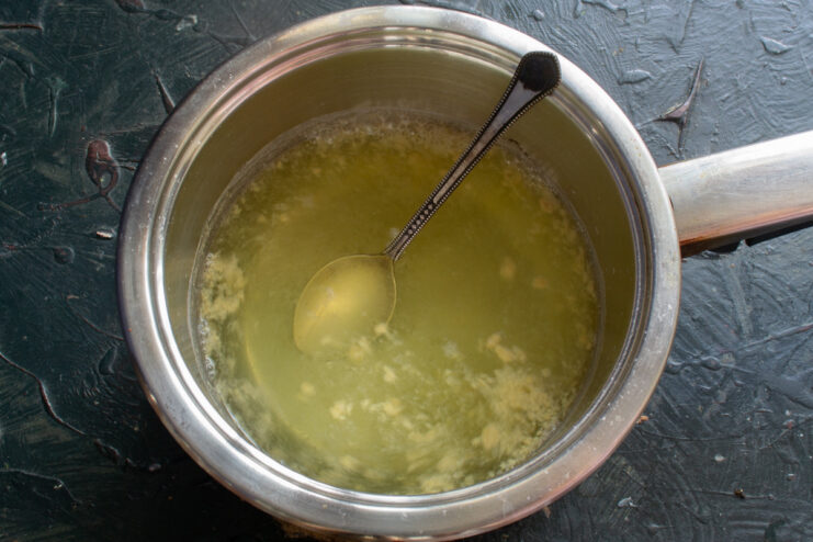 Making the Zesty Mustard Brine Mustard powder being added to a saucepan with water and salt to create the brine.
