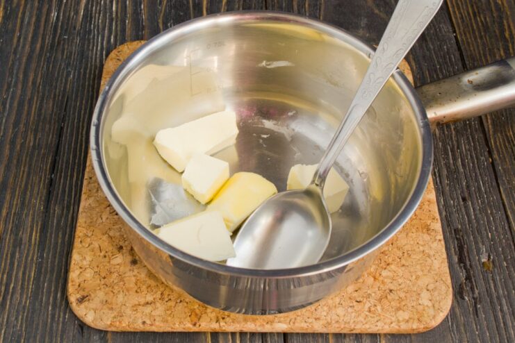 Starting the Polish Sauce: Melting the Butter Cubes of butter melting in a small saucepan over low heat.