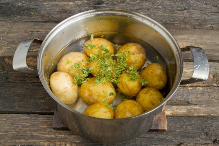 Boiling New Potatoes Until Tender New potatoes boiling in a pot on the stove.