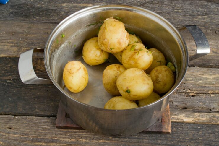 Drying Boiled Potatoes Before Frying for Extra Crispiness Boiled new potatoes in a dry pot, steaming to remove excess moisture.