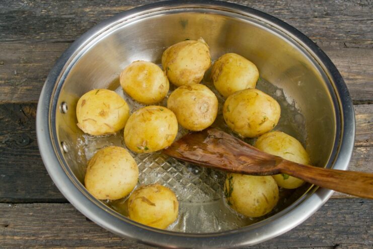 Frying New Potatoes to a Perfect Golden Brown Boiled new potatoes being pan-fried until crispy on one side.