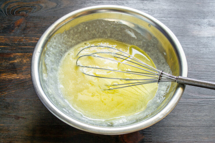 Step 3: Incorporating Vegetable Oil into the Batter Pouring neutral vegetable oil into the cupcake batter mixture.