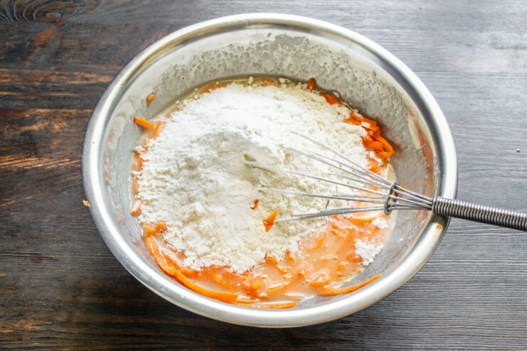 Step 5: Combining the Dry Ingredients for the Cupcakes A bowl with flour, baking powder, and vanilla powder being mixed together.